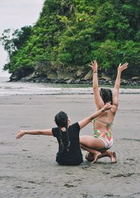 Rear view of girls on beach