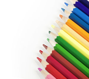 Close-up of colored pencils against white background