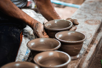 Midsection of man making pottery