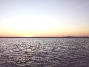 Scenic view of sea against clear sky during sunset