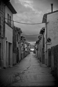 Street amidst buildings against sky