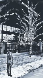 Full length portrait of woman standing in snow