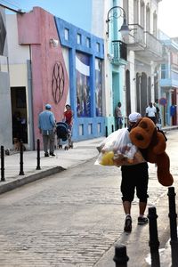 Rear view of a man walking in city