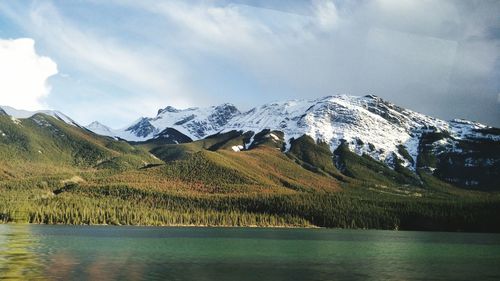 Scenic view of lake and mountains against sky