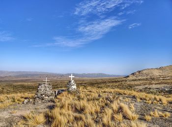 Scenic view of land against blue sky