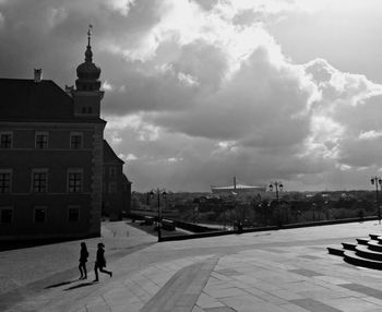 People in city against sky