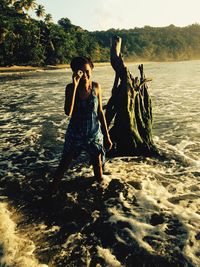 Full length of woman standing on shore