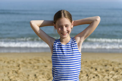 Portrait of smiling girl standing at beach