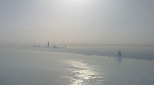 Scenic view of sea against sky during winter