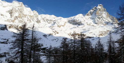 Scenic view of snowcapped mountains against clear sky