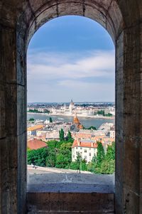 Cityscape against sky seen through arch