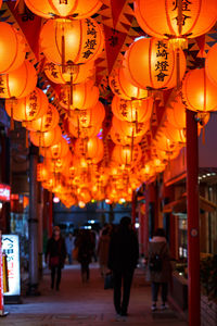 Illuminated lanterns hanging in city at night