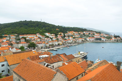 High angle view of houses in town against sky