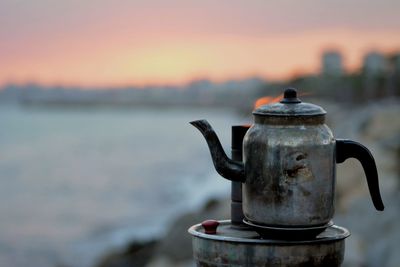 Close-up of tea against sky during sunset