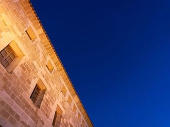 Low angle view of building against blue sky