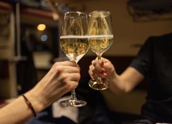 Midsection of woman holding wineglass