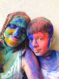 Portrait of young man with multi colored face