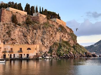 Panoramic view of sea and buildings against sky