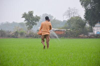 Rear view of man on field