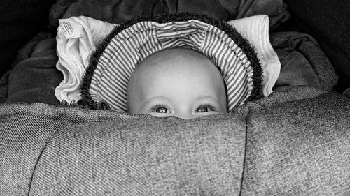 Portrait of cute baby relaxing on bed