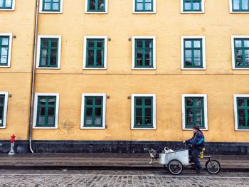 People working on street against building in city