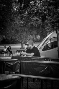 People sitting on table against trees