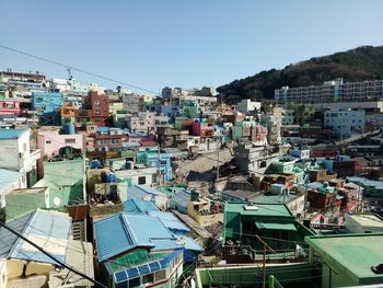 High angle view of buildings against clear blue sky