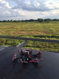 Motorcycle on field against sky