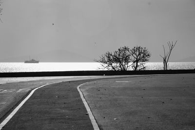 Road by sea against sky