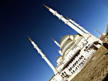 Low angle view of crane against clear sky