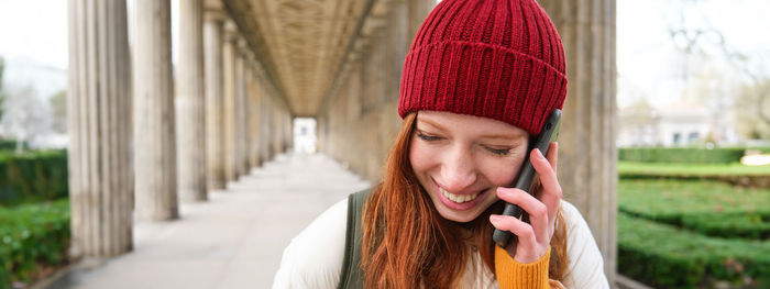 Portrait of young woman wearing hat