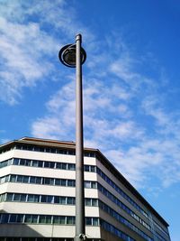 Low angle view of building against cloudy sky
