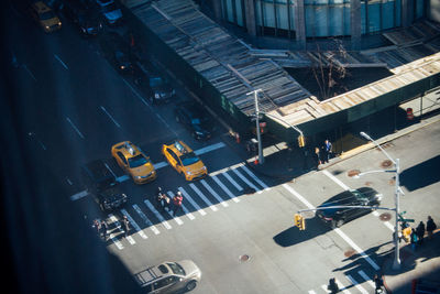 High angle view of vehicles on road along buildings