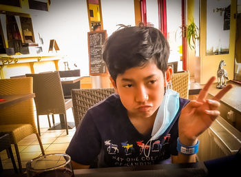 Portrait of boy sitting on table