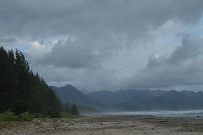 Scenic view of sea and mountains against sky