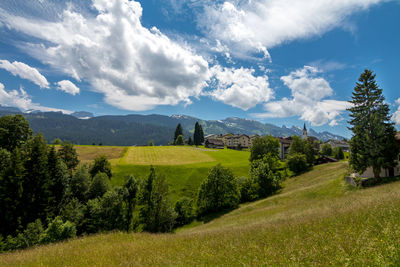 View of fields against cloudy sky