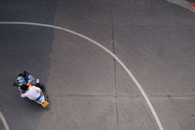 High angle view of woman sitting on road