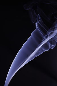 Close-up of blue light against black background
