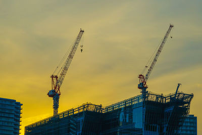 Low angle view of crane against sky