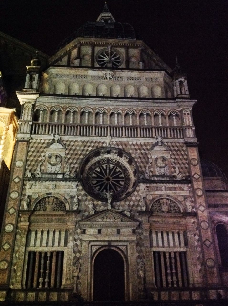 architecture, low angle view, built structure, building exterior, arch, religion, church, place of worship, history, spirituality, night, facade, travel destinations, window, famous place, ornate, illuminated, sky