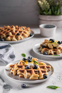 Breakfast with waffles with blueberries and syrup on a plates