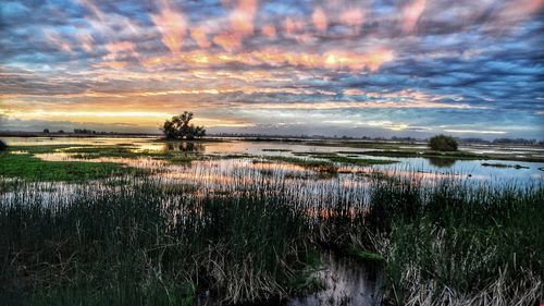 Scenic view of lake against sky during sunset