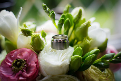 Close-up of flowers and wedding ring