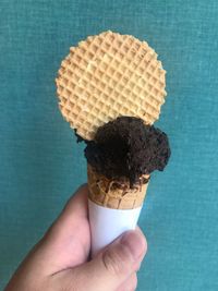 Close-up of hand holding ice cream cone