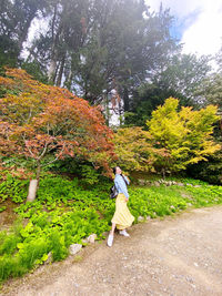 Man standing by plants and trees during autumn