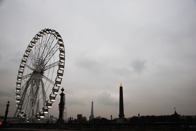 Low angle view of ferris wheel against sky