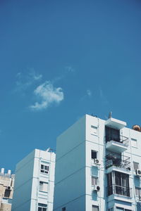 Low angle view of buildings against blue sky