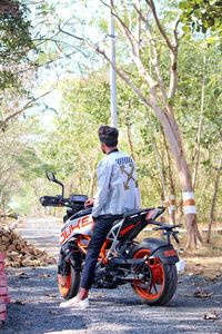 Rear view of man riding motorcycle