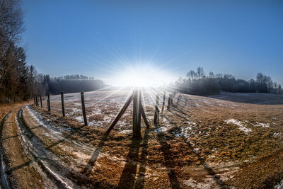 Sun shining over snow covered landscape