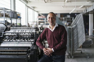 Smiling mature man in a printing shop